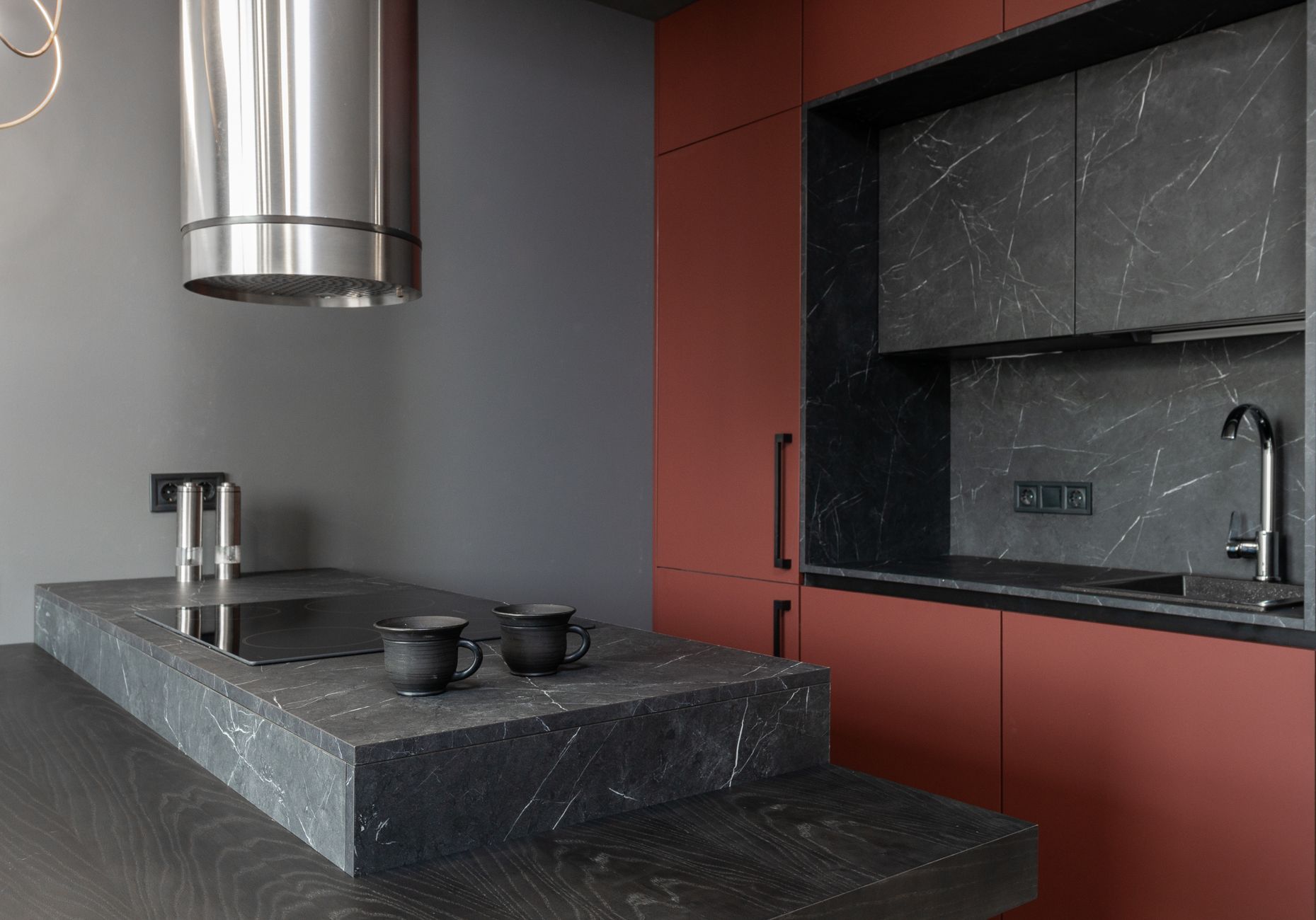 Minimalist style interior design of modern home kitchen with stove built in gray island countertop under in Riverside, CA